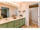 Bathroom featuring double sinks, ample mirror space, with a shower/tub combo behind a shower curtain at 4969 Thorndike Ave, Castle Rock, CO 80104