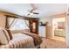 Bedroom with a plush bed, wooden wardrobe, and a view into the ensuite bathroom with vanity at 4969 Thorndike Ave, Castle Rock, CO 80104