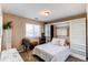 Cozy bedroom featuring built in storage shelves, a decorative mirror and plants at 4969 Thorndike Ave, Castle Rock, CO 80104