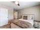 Bedroom with neutral walls, plush bed, and a door leading to the hallway and bedroom closet at 4969 Thorndike Ave, Castle Rock, CO 80104