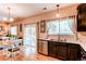 Functional kitchen area featuring dark wood cabinetry, stainless steel appliances, and access to the patio at 4969 Thorndike Ave, Castle Rock, CO 80104