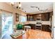 Stylish kitchen featuring dark wood cabinets, stainless steel appliances, and an adjacent dining area at 4969 Thorndike Ave, Castle Rock, CO 80104