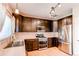 Modern kitchen with stainless steel appliances, dark wood cabinetry, and sleek countertops at 4969 Thorndike Ave, Castle Rock, CO 80104