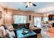 Inviting living room featuring a leather sectional, dining area, and sliding doors to the backyard at 4969 Thorndike Ave, Castle Rock, CO 80104