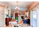 Cozy living room with a leather sectional, dining table, and sliding doors to the outside patio at 4969 Thorndike Ave, Castle Rock, CO 80104