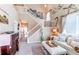 Inviting living room featuring a vaulted ceiling, wall decor, plush seating, and access to a dining area at 4969 Thorndike Ave, Castle Rock, CO 80104