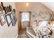 Bright stairway with decorative wall art, natural light from the window, and a carpeted staircase at 4969 Thorndike Ave, Castle Rock, CO 80104