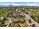 An aerial view shows the home nestled in a vibrant neighborhood near mountains under a blue sky at 10970 W Florida Ave # 225, Lakewood, CO 80232