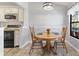 Dining area with round wooden table and chairs, bright natural light at 10970 W Florida Ave # 225, Lakewood, CO 80232