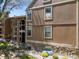 A view of the building's exterior, featuring stone accents and well-maintained landscaping at 10970 W Florida Ave # 225, Lakewood, CO 80232