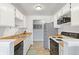 Bright kitchen features white cabinets, wood countertops and stainless steel appliances at 10970 W Florida Ave # 225, Lakewood, CO 80232