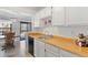 Kitchen with wood countertops, white cabinets and dining area at 10970 W Florida Ave # 225, Lakewood, CO 80232