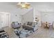 Open living room with wood floor, gray sofa, and dining area at 10970 W Florida Ave # 225, Lakewood, CO 80232
