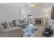 Bright living room with fireplace, gray sofas, and sliding door at 10970 W Florida Ave # 225, Lakewood, CO 80232