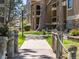 A charming walkway lined with wooden posts and rope leads to the building's entrance and grassy areas at 10970 W Florida Ave # 225, Lakewood, CO 80232