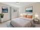 Stylishly staged bedroom showcasing soft colors, decor and natural light at 331 Wright St # 108, Lakewood, CO 80228