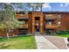 Charming brown wood condo with multiple balconies and well-maintained lawn and landscape at 331 Wright St # 108, Lakewood, CO 80228