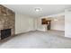 Spacious living area with a stone fireplace seamlessly connected to the kitchen at 331 Wright St # 108, Lakewood, CO 80228
