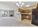 Open concept living room with a stone fireplace and updated kitchen area at 331 Wright St # 108, Lakewood, CO 80228