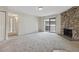 Bright living room with a stone fireplace and sliding glass doors to the outdoor patio at 331 Wright St # 108, Lakewood, CO 80228
