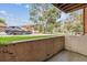 View of the patio with greenery, parked cars and blue skies at 331 Wright St # 108, Lakewood, CO 80228