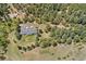 Secluded property features house and garage surrounded by lush, mature trees at 27436 Kennedy Gulch Rd, Conifer, CO 80433