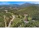 Scenic aerial shot of a home surrounded by lush forests, offering privacy and stunning mountain views at 27436 Kennedy Gulch Rd, Conifer, CO 80433