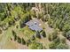 An aerial view of a secluded house surrounded by lush greenery and a long driveway at 27436 Kennedy Gulch Rd, Conifer, CO 80433