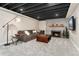 Cozy basement with a brick fireplace, neutral walls and carpet, a gray couch and recessed lighting at 27436 Kennedy Gulch Rd, Conifer, CO 80433