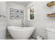 Bathroom featuring a standalone tub, white walls, a modern faucet and a window with a view of greenery at 27436 Kennedy Gulch Rd, Conifer, CO 80433