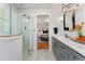 Bright bathroom with a double vanity, modern lighting and a view of the bedroom with a large bed at 27436 Kennedy Gulch Rd, Conifer, CO 80433