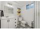 Stylish bathroom features a white vanity, patterned floor, and glass-enclosed shower at 27436 Kennedy Gulch Rd, Conifer, CO 80433