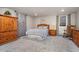 Bedroom with neutral walls and carpet, a wooden bed set and a window with horizontal blinds at 27436 Kennedy Gulch Rd, Conifer, CO 80433