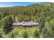 Beautiful ranch-style home in a serene, wooded setting with a spacious backyard and deck at 27436 Kennedy Gulch Rd, Conifer, CO 80433