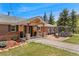 Charming ranch-style home featuring a welcoming front porch and pergola-covered patio at 27436 Kennedy Gulch Rd, Conifer, CO 80433