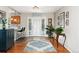 Inviting foyer with hardwood floors and views of the open floorplan kitchen and dining area at 27436 Kennedy Gulch Rd, Conifer, CO 80433