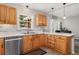 Bright kitchen with oak cabinets, stainless steel dishwasher, and a breakfast bar at 27436 Kennedy Gulch Rd, Conifer, CO 80433