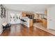 Open concept kitchen with modern appliances, wood cabinets, and an adjacent sitting area at 27436 Kennedy Gulch Rd, Conifer, CO 80433