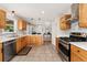 Well-lit kitchen featuring wooden cabinets, stainless steel appliances, and an open layout at 27436 Kennedy Gulch Rd, Conifer, CO 80433