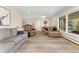 Inviting living room with lots of seating, hardwood floors, and a large picture window at 27436 Kennedy Gulch Rd, Conifer, CO 80433