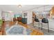 Open-concept living space featuring hardwood floors and seamless transitions to kitchen and dining area at 27436 Kennedy Gulch Rd, Conifer, CO 80433