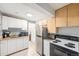 Compact kitchen features a stainless steel fridge and white cabinets at 401 N Columbine St, Golden, CO 80403