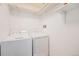 Clean laundry area featuring a washer, dryer, and storage shelves at 401 N Columbine St, Golden, CO 80403