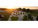 Expansive aerial view of the two-story home, highlighting the surrounding acreage and white fencing at sunset at 2495 Red Hawk Pl, Broomfield, CO 80023