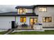 Home exterior showcasing a patio with a built-in grill, dining table, and manicured lawn at 2495 Red Hawk Pl, Broomfield, CO 80023