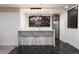 Entertainer's basement featuring a bar with modern lighting, countertop seating, and stylish decor at 2495 Red Hawk Pl, Broomfield, CO 80023