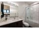 Stylish bathroom featuring a sleek vanity, a shower-tub combo, and updated fixtures and finishes at 2495 Red Hawk Pl, Broomfield, CO 80023