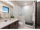 Modern bathroom featuring marble tiling, glass shower, and sleek vanity creating a luxurious space at 2495 Red Hawk Pl, Broomfield, CO 80023
