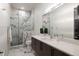 Contemporary bathroom featuring glass-enclosed shower, marble tiling, and modern fixtures at 2495 Red Hawk Pl, Broomfield, CO 80023