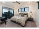 Cozy bedroom with vaulted ceilings, large windows, and a private balcony providing ample natural light at 2495 Red Hawk Pl, Broomfield, CO 80023